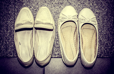 Antique women shoes decorated with bows, Vintage color filter