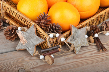 Orange in wickered tray with Christmas decor