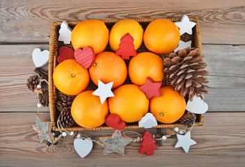 Orange in wickered tray with Christmas decor