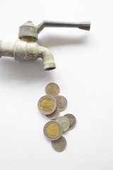 coin money flow out form steel faucet on white background