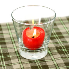 Red candles in glass tableware.