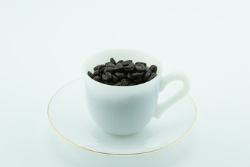 Cup of coffee beans isolate on white background.