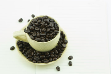 Cup of coffee beans isolate on white background.