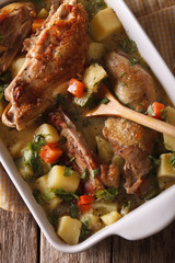 Pieces of chicken stewed with vegetables closeup. vertical top view
