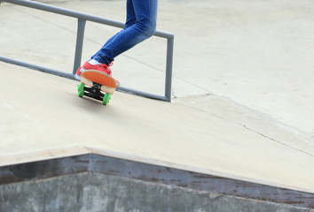 Fototapeta na wymiar skateboarding legs at skatepark
