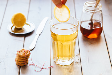 tea with lemon and honey on wooden background