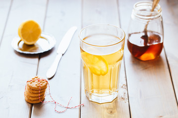 tea with lemon and honey on wooden background