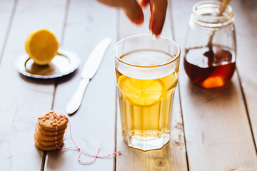 tea with lemon and honey on wooden background