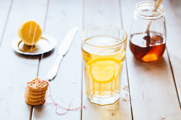 tea with lemon and honey on wooden background