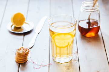 tea with lemon and honey on wooden background