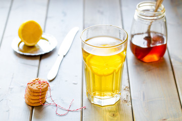 tea with lemon and honey on wooden background
