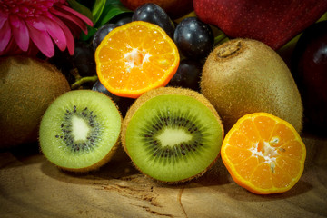 Naklejka na ściany i meble Assortment of exotic fruits on wood background.