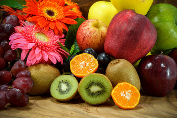 Assortment of exotic fruits on wood background.