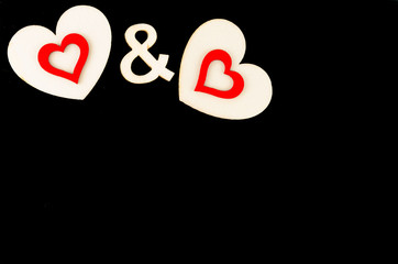 Pair of heart shapes symbols isolated on black, available copy space, love concept