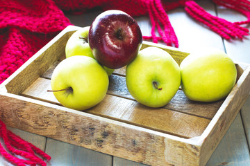 red and green apples in a box