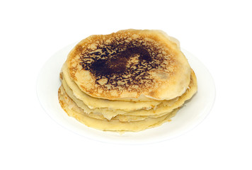 Stack of many fried pancakes on round  white plate isolated on white background. Photo closeup