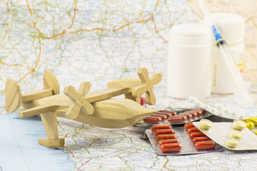 traveler's first aid kit, plane, pill, map