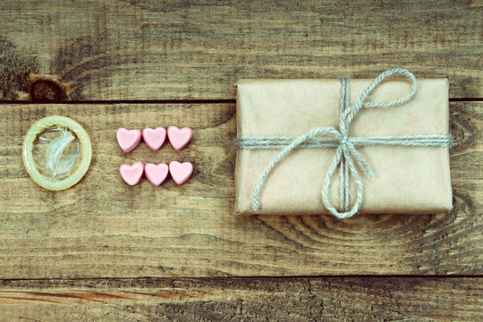 Condom, heart shapes and gift box