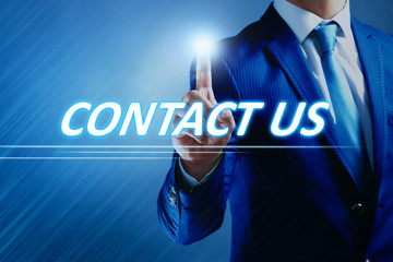 Businessman pressing contact us button on virtual screen. Internet and networking concept.