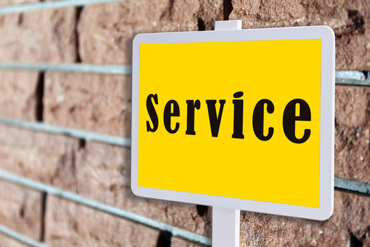 Signboard with text Service on brick wall background