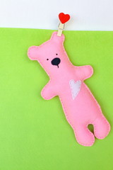 Felt bear - pink felt bear on green background, hand-stitched toy