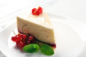Delicious cheesecake with berries on table close up
