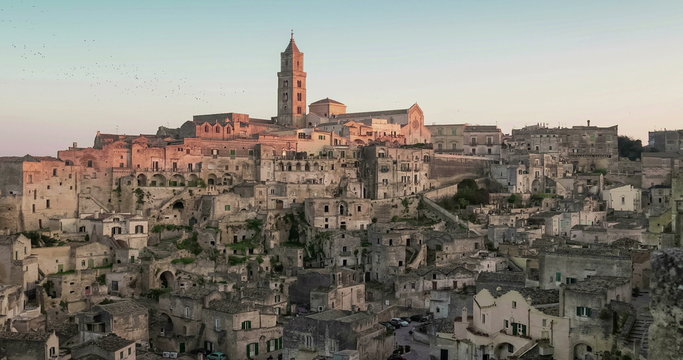 panoramic view of typical stones and church of Matera under sunset sky time lapse, 4K and 1080p
