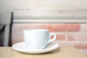 Cup of tasty coffee on cafe background