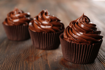 Chocolate cupcakes on dark wooden background