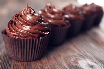 Chocolate cupcakes on dark wooden background