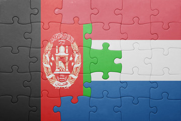 puzzle with the national flag of netherlands and afghanistan