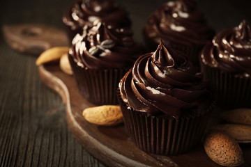 Chocolate cupcakes with nuts on cutting board