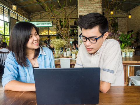 Asian businessman and woman meeting with laptop