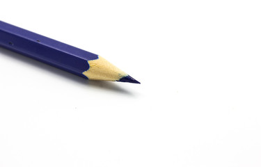Blue pencil  on white background close up