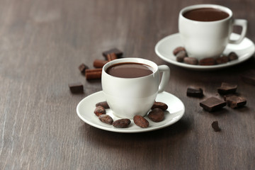 Cacao with beans and chocolate on wooden background