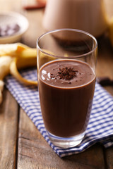 Glass of chocolate milk on table close-up