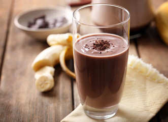 Glass of chocolate milk on table close-up