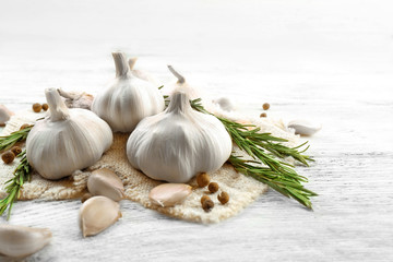 Composition of garlic and rosemary on wooden background