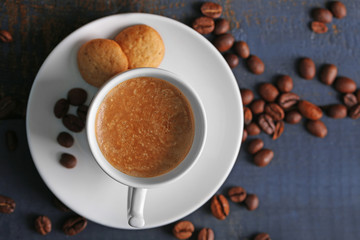 Cup of coffee on wooden table background