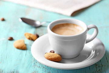 Cup of coffee on color wooden background