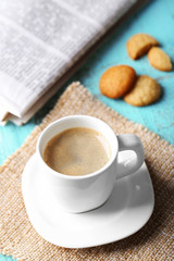 Cup of coffee on color wooden background
