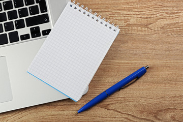 Empty  notebook on laptop keyboard, on light background