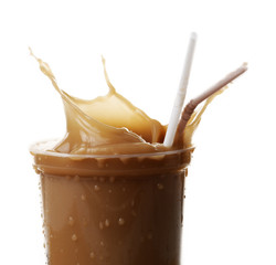 Cup of ice coffee with splashes, isolated on white