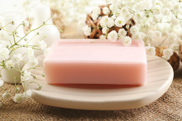 Soap on a dish over wooden background, close up