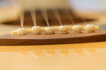 Closeup acoustic guitar bridge
