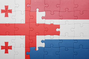 Fototapeta premium puzzle with the national flag of netherlands and georgia
