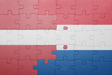 puzzle with the national flag of netherlands and latvia
