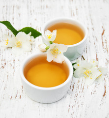 Cups of tea with jasmine flowers