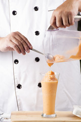 Pouring Thai Tea smoothie to the glass