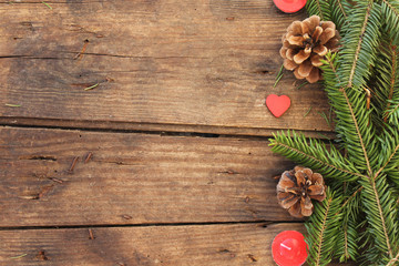 Fototapeta na wymiar Christmas background with pine cone, candle, heart and fir branches
